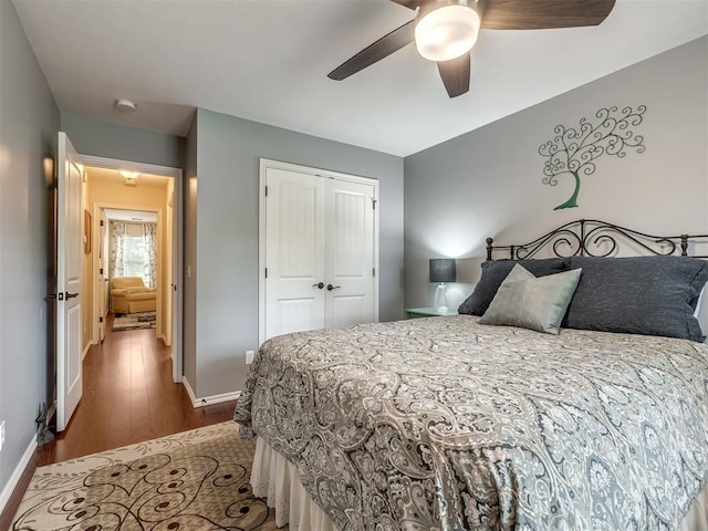 3570 Riverwood Ln, Edmond, OK 73034 - bedroom with wood finished floors, baseboards, a closet, and ceiling fan