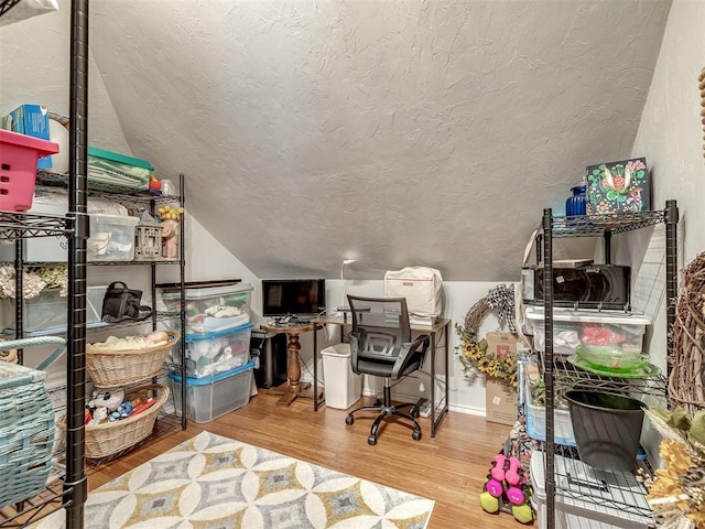 3570 Riverwood Ln, Edmond, OK 73034 - office space with vaulted ceiling, wood finished floors, and a textured ceiling