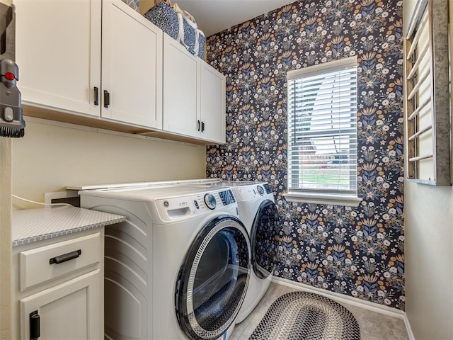 3570 Riverwood Ln, Edmond, OK 73034 - clothes washing area with cabinet space, wallpapered walls, washer and clothes dryer, plenty of natural light, and baseboards