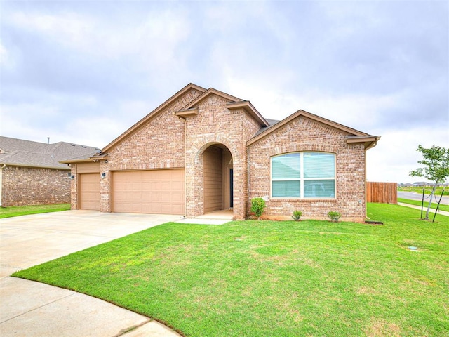 10301 NW 25th St, Yukon, OK 73099 - view of front of property featuring brick siding, driveway, and an attached garage