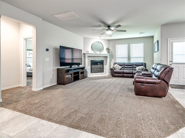 10301 NW 25th St, Yukon, OK 73099 - carpeted living area featuring ceiling fan, a glass covered fireplace, and baseboards