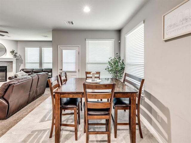 10301 NW 25th St, Yukon, OK 73099 - dining room with a glass covered fireplace, ceiling fan, recessed lighting, and light tile patterned flooring