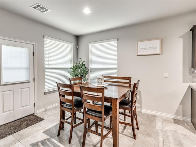 10301 NW 25th St, Yukon, OK 73099 - dining area featuring light tile patterned floors, baseboards, and recessed lighting