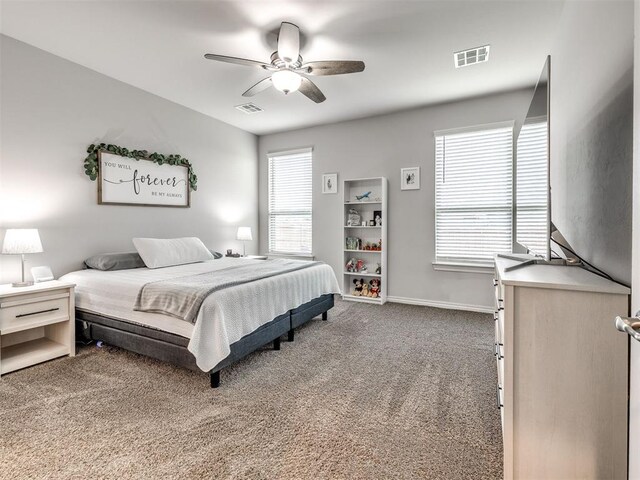 10301 NW 25th St, Yukon, OK 73099 - bedroom with carpet floors, baseboards, and a ceiling fan