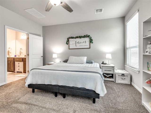 10301 NW 25th St, Yukon, OK 73099 - carpeted bedroom featuring ensuite bath, ceiling fan, and baseboards