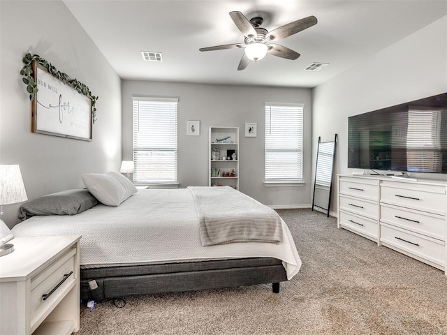 10301 NW 25th St, Yukon, OK 73099 - bedroom featuring light colored carpet, multiple windows, ceiling fan, and baseboards