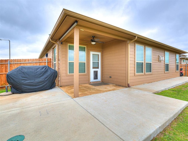 10301 NW 25th St, Yukon, OK 73099 - back of house featuring a ceiling fan, a patio area, and fence