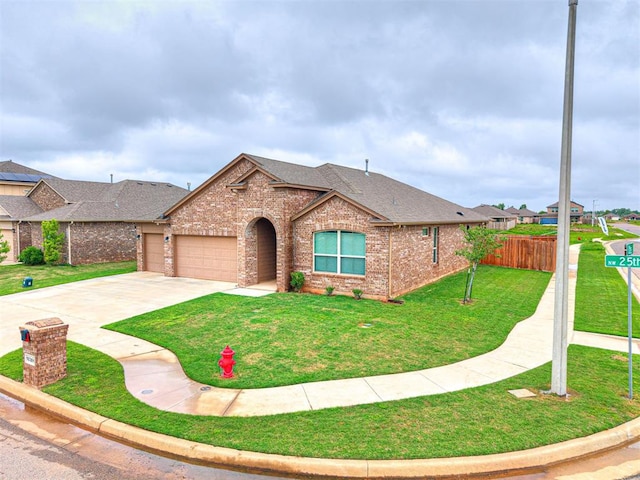10301 NW 25th St, Yukon, OK 73099 - view of front of property featuring brick siding, a shingled roof, an attached garage, and driveway