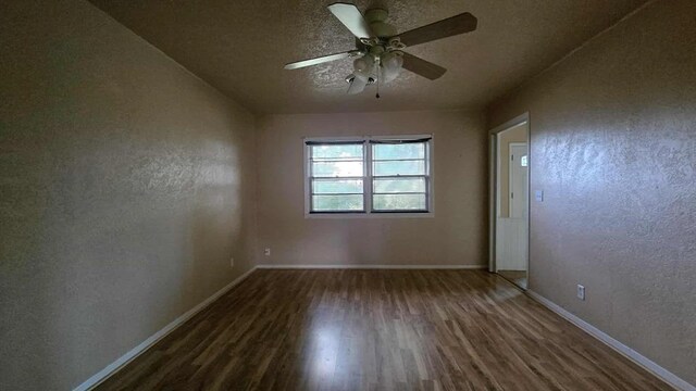 unfurnished room with wood finished floors, baseboards, a ceiling fan, a textured wall, and a textured ceiling