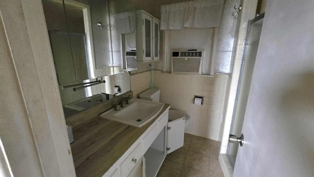 bathroom featuring tile patterned flooring, tile walls, toilet, vanity, and cooling unit