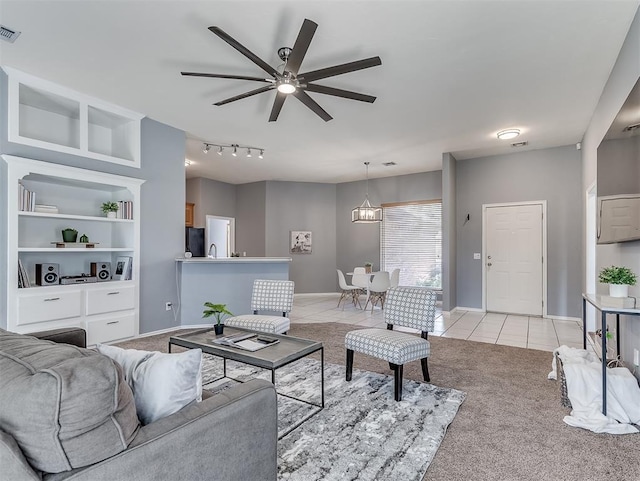 4900 Republic Dr, Oklahoma City, OK 73135 - living area featuring light tile patterned floors, ceiling fan, light colored carpet, and baseboards