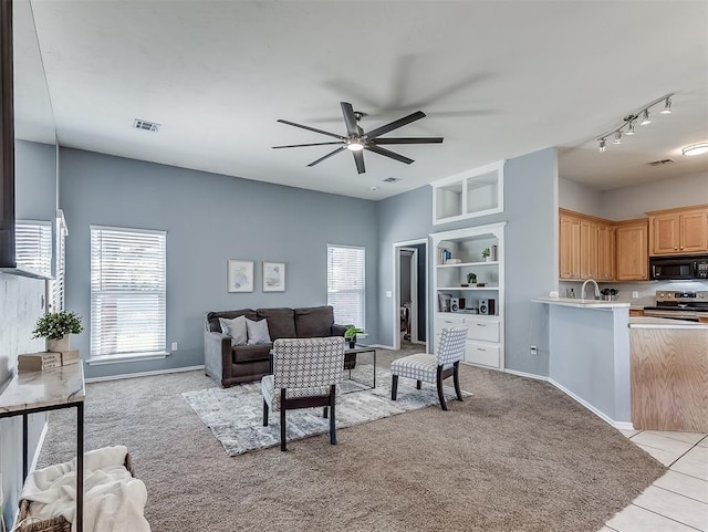 4900 Republic Dr, Oklahoma City, OK 73135 - living room with a ceiling fan, plenty of natural light, and light colored carpet