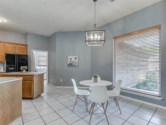 4900 Republic Dr, Oklahoma City, OK 73135 - dining area featuring washer / dryer, a chandelier, light tile patterned flooring, and baseboards