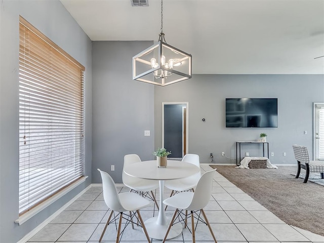 4900 Republic Dr, Oklahoma City, OK 73135 - dining space featuring light tile patterned floors, a chandelier, and baseboards
