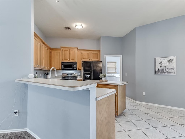 4900 Republic Dr, Oklahoma City, OK 73135 - kitchen with black appliances, a peninsula, light countertops, and baseboards