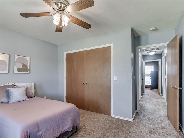 4900 Republic Dr, Oklahoma City, OK 73135 - bedroom with light carpet, a closet, ceiling fan, and baseboards