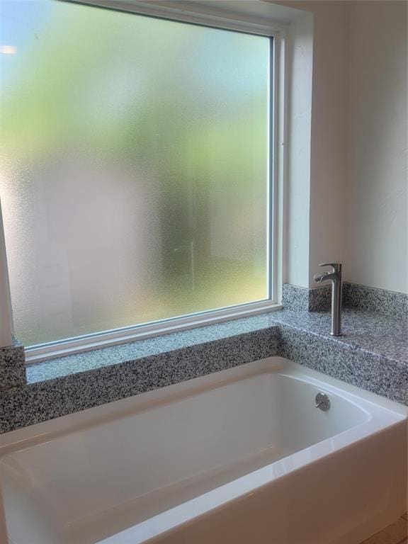 bathroom featuring a garden tub