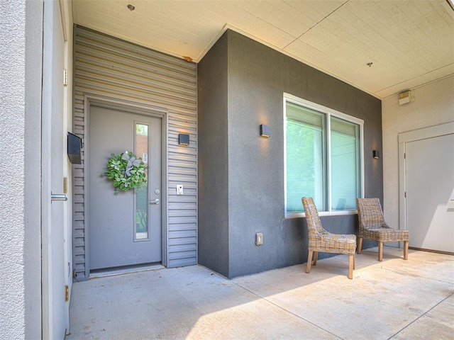 view of exterior entry featuring stucco siding