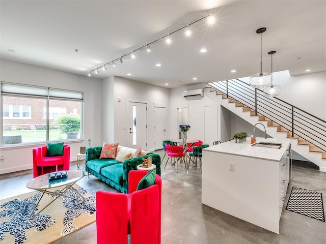 living room with a wall unit AC, concrete flooring, stairway, track lighting, and recessed lighting