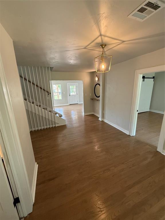 1212 NW 48th St, Oklahoma City, OK 73118 - hall featuring wood finished floors, baseboards, stairway, and a barn door