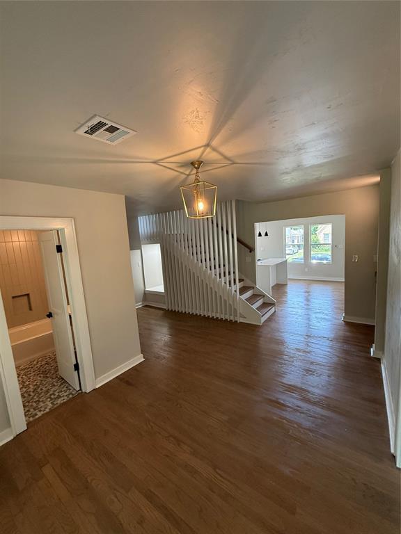 1212 NW 48th St, Oklahoma City, OK 73118 - unfurnished living room with wood finished floors and baseboards