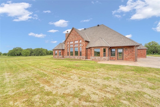 21698 SW Coombs Rd, Cache, OK 73527 - back of property featuring a patio area, a chimney, a yard, brick siding, and roof with shingles