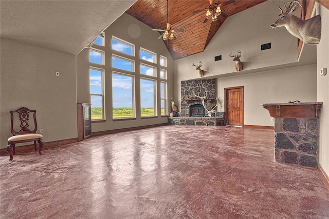 21698 SW Coombs Rd, Cache, OK 73527 - unfurnished living room featuring a stone fireplace, ceiling fan, high vaulted ceiling, wood ceiling, and concrete flooring