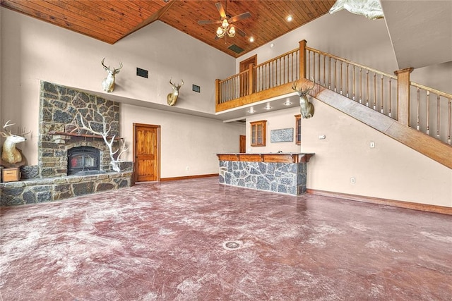 21698 SW Coombs Rd, Cache, OK 73527 - unfurnished living room featuring wood ceiling, concrete floors, stairs, a towering ceiling, and a fireplace
