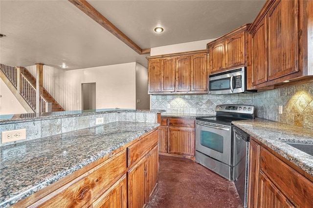 21698 SW Coombs Rd, Cache, OK 73527 - kitchen featuring stainless steel appliances, stone countertops, tasteful backsplash, brown cabinets, and recessed lighting