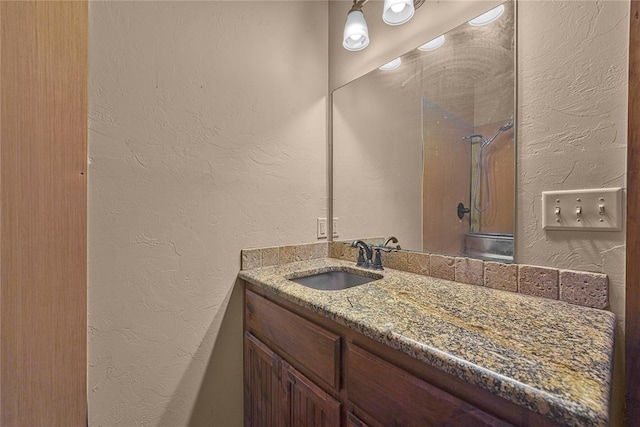 21698 SW Coombs Rd, Cache, OK 73527 - full bathroom with a textured wall, vanity, and a shower