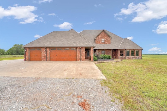 21698 SW Coombs Rd, Cache, OK 73527 - view of front of house with driveway, brick siding, a front lawn, and a garage