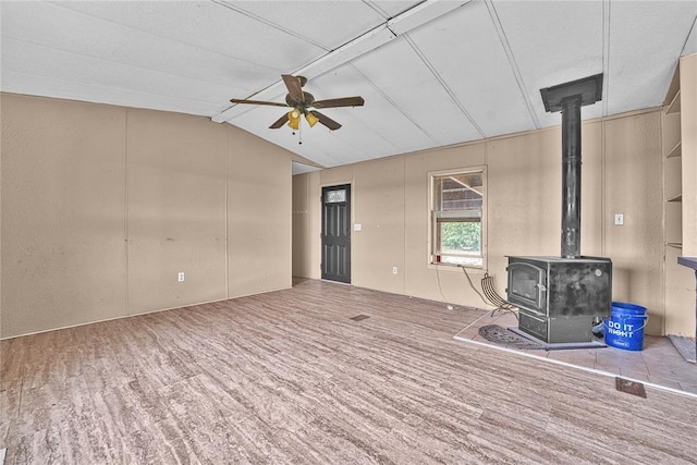 21698 SW Coombs Rd, Cache, OK 73527 - unfurnished living room featuring a ceiling fan, a wood stove, and vaulted ceiling