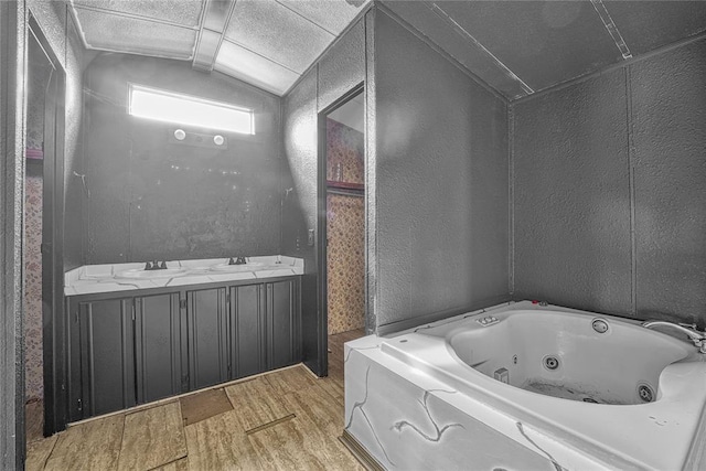 21698 SW Coombs Rd, Cache, OK 73527 - full bath with wood finished floors, lofted ceiling, and a jetted tub