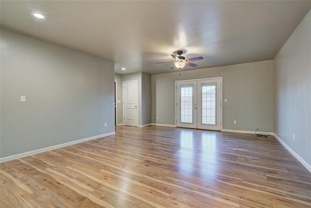 403 S Debra Ct Unit 401, Stillwater, OK 74074 - spare room with a ceiling fan, baseboards, light wood-style floors, french doors, and recessed lighting