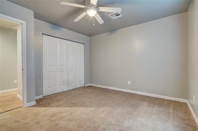 403 S Debra Ct Unit 401, Stillwater, OK 74074 - unfurnished bedroom with carpet, baseboards, a closet, and a ceiling fan