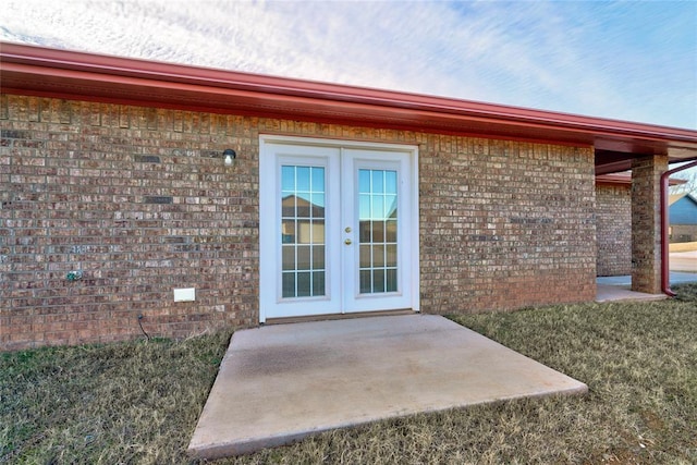 403 S Debra Ct Unit 401, Stillwater, OK 74074 - doorway to property featuring french doors, brick siding, and a patio