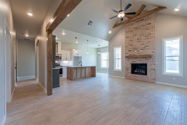 9205 Taggert Ln, Yukon, OK 73099 - unfurnished living room featuring a sink, ceiling fan, high vaulted ceiling, baseboards, and beamed ceiling