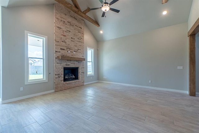 9205 Taggert Ln, Yukon, OK 73099 - unfurnished living room featuring a ceiling fan, beam ceiling, high vaulted ceiling, a fireplace, and wood finish floors