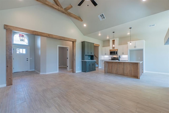 9205 Taggert Ln, Yukon, OK 73099 - kitchen featuring stainless steel appliances, high vaulted ceiling, open floor plan, a ceiling fan, and baseboards