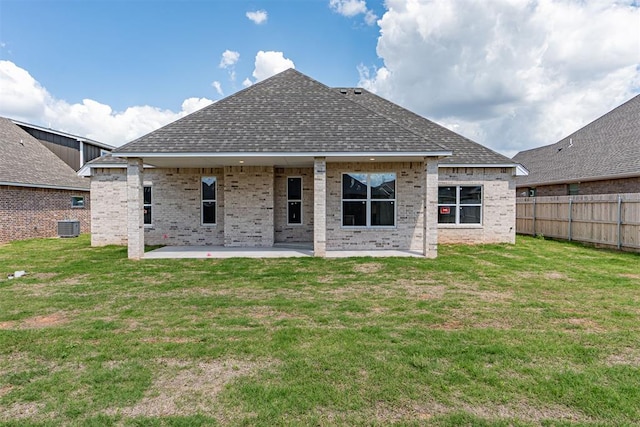 9205 Taggert Ln, Yukon, OK 73099 - back of property with a patio, roof with shingles, brick siding, and cooling unit