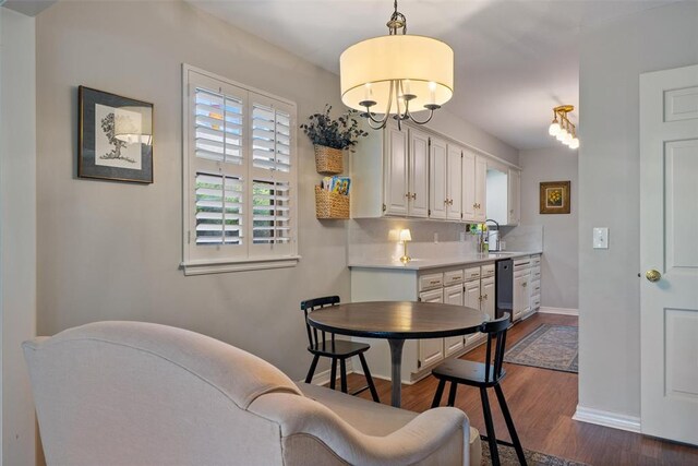3804 NW 66th St, Oklahoma City, OK 73116 - dining space with dark wood-type flooring, baseboards, and a chandelier