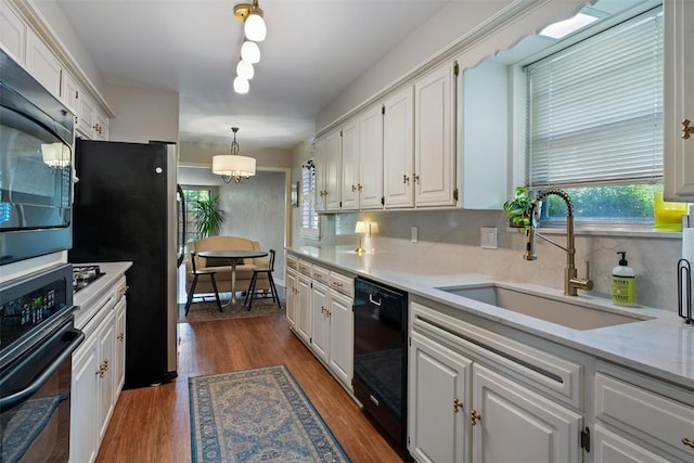 3804 NW 66th St, Oklahoma City, OK 73116 - kitchen featuring black appliances, a sink, white cabinets, and healthy amount of natural light