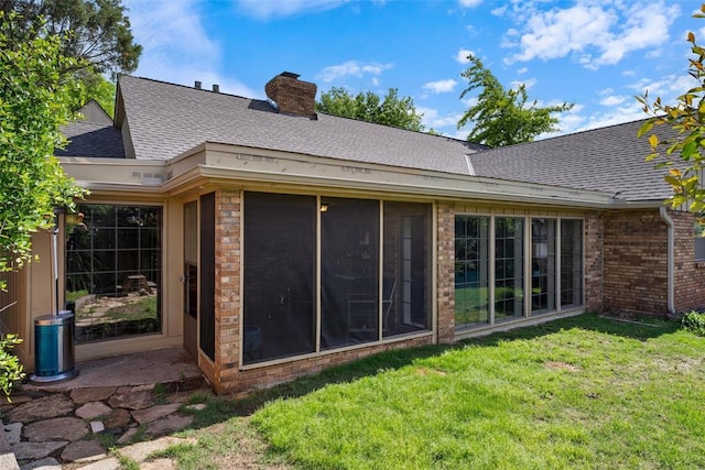 3804 NW 66th St, Oklahoma City, OK 73116 - rear view of house featuring a yard, brick siding, roof with shingles, and a chimney