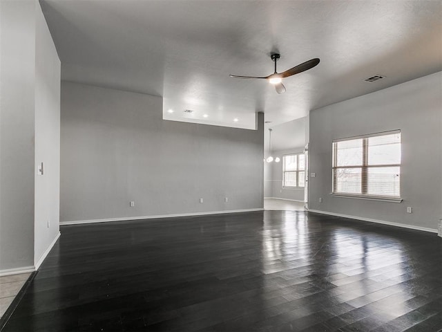 unfurnished room with ceiling fan, dark wood-style flooring, and baseboards