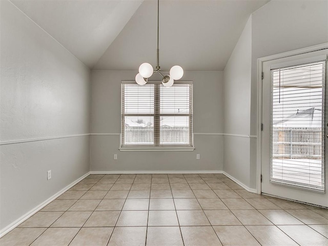 unfurnished room with a chandelier, lofted ceiling, light tile patterned flooring, and baseboards