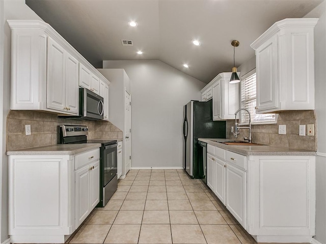 kitchen with range with electric cooktop, stainless steel microwave, white cabinetry, vaulted ceiling, and backsplash
