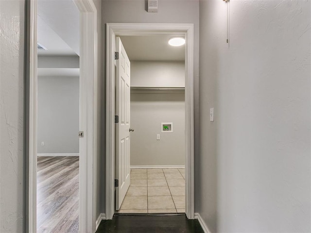 hall with tile patterned flooring and baseboards