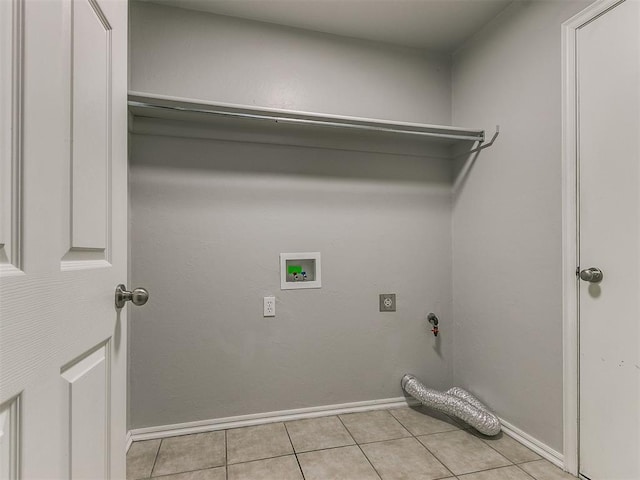 washroom with washer hookup, light tile patterned floors, baseboards, and electric dryer hookup