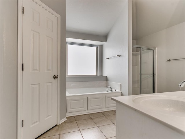 bathroom with a shower stall, tile patterned flooring, and a garden tub