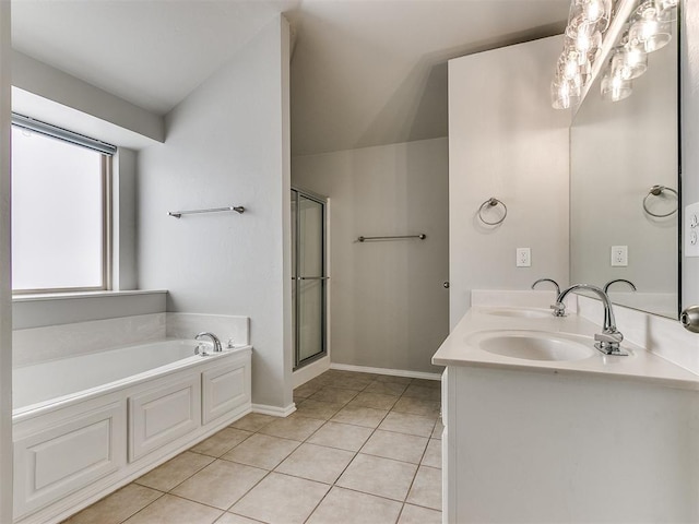 full bath featuring a bath, tile patterned floors, a shower stall, double vanity, and baseboards
